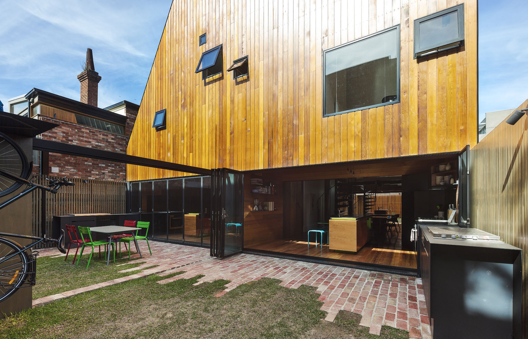 Zasklená stena medzi susediacimi terasami vytvára veľký zadný dvor. Architekti rešpektovali existujúce paralelné viktoriánske terasy, ktoré sa rozhodli zrekonštruovať a zreštaurovať.